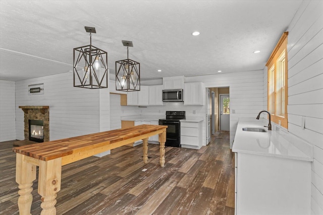 1483 Resaca Lafayette Rd NW, Resaca, GA 30735 - kitchen with black electric range oven, stainless steel microwave, dark wood-style flooring, a textured ceiling, and light countertops