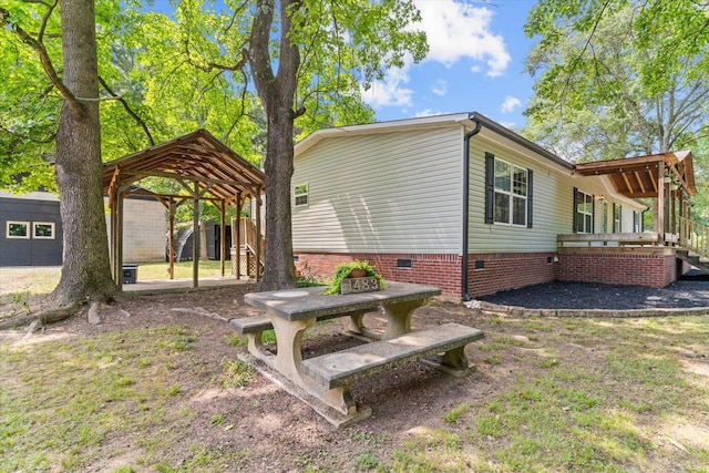 1483 Resaca Lafayette Rd NW, Resaca, GA 30735 - view of home's exterior with a carport, crawl space, and a deck