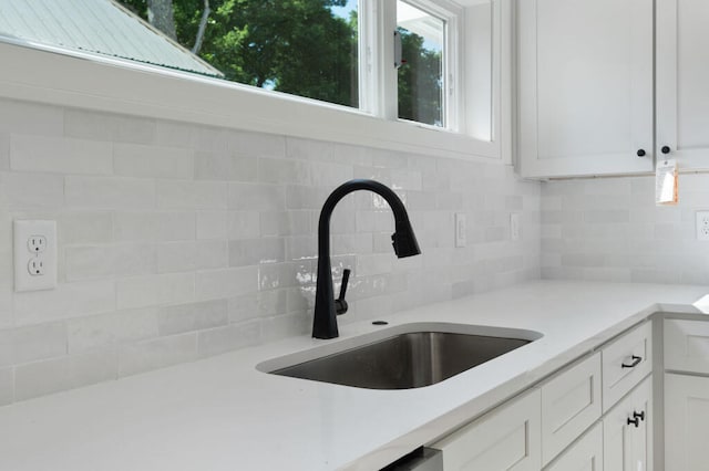 1306 Top St, Chattanooga, TN 37408 - kitchen view of tasteful backsplash, white cabinets, and light countertops