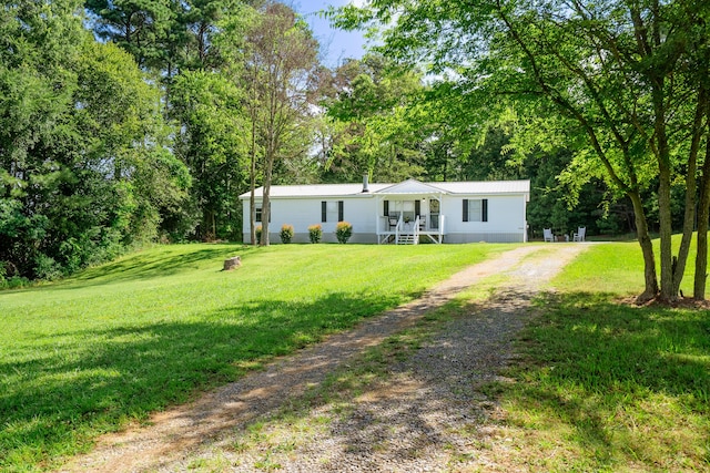 63 Applewood Ln, Chatsworth, GA 30705 - manufactured / mobile home with driveway, a front yard, view of scattered trees, and a metal roof