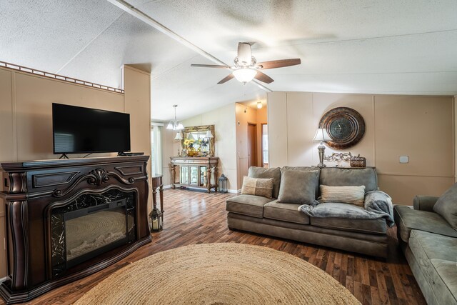 63 Applewood Ln, Chatsworth, GA 30705 - living area featuring vaulted ceiling, ceiling fan, wood finished floors, a glass covered fireplace, and a textured ceiling