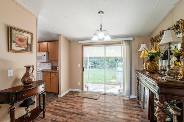 63 Applewood Ln, Chatsworth, GA 30705 - dining space with dark wood-style flooring and a chandelier