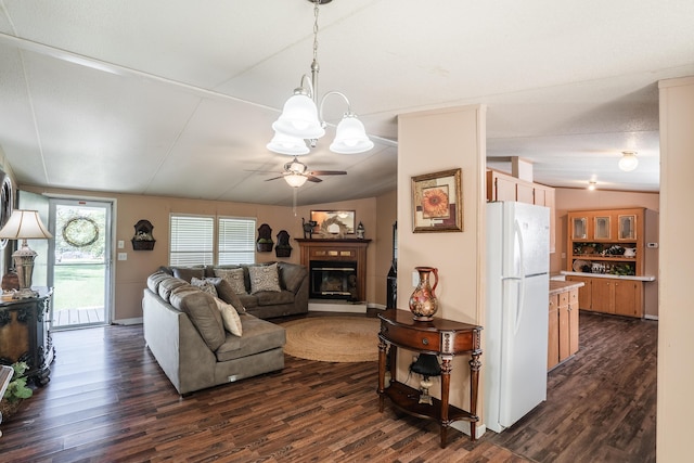 63 Applewood Ln, Chatsworth, GA 30705 - living area featuring dark wood finished floors, a chandelier, a ceiling fan, a glass covered fireplace, and vaulted ceiling