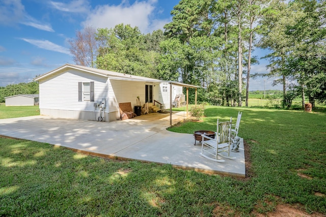 63 Applewood Ln, Chatsworth, GA 30705 - rear view of house featuring entry steps, a patio area, and a yard