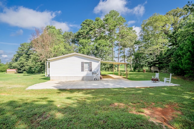 63 Applewood Ln, Chatsworth, GA 30705 - view of grassy yard with a fire pit, a patio, and view of wooded area
