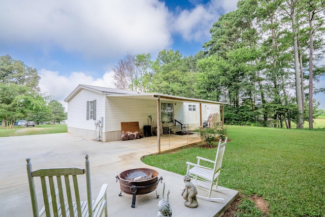 63 Applewood Ln, Chatsworth, GA 30705 - back of house with a yard, a fire pit, entry steps, a metal roof, and a patio