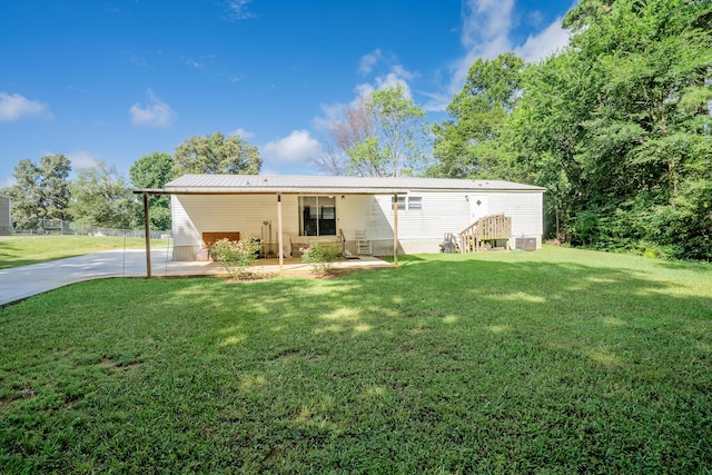 63 Applewood Ln, Chatsworth, GA 30705 - rear view of house with a yard and a metal roof