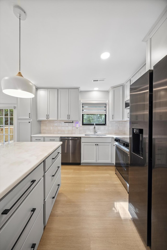 2427 Maplewood Dr, Chattanooga, TN 37421 - kitchen featuring stainless steel appliances, backsplash, light countertops, plenty of natural light, and recessed lighting