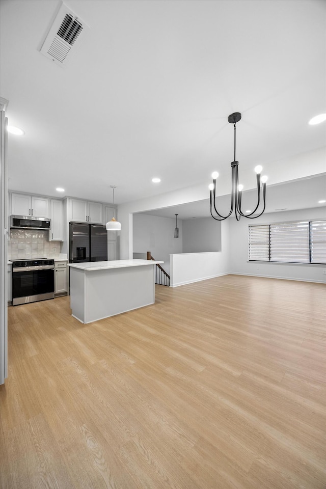 2427 Maplewood Dr, Chattanooga, TN 37421 - unfurnished living room featuring light wood-style floors, a chandelier, and recessed lighting