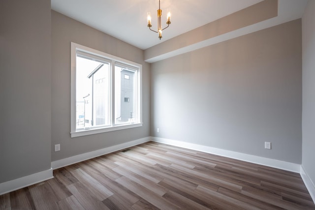 745 Burnside Pl, Chattanooga, TN 37408 - empty room with a chandelier and wood finished floors