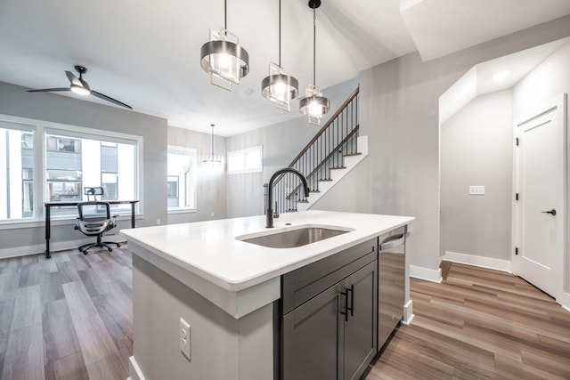 745 Burnside Pl, Chattanooga, TN 37408 - kitchen with light countertops, light wood-style floors, a ceiling fan, hanging light fixtures, and stainless steel dishwasher