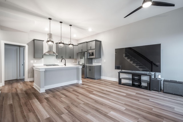 745 Burnside Pl, Chattanooga, TN 37408 - kitchen with gray cabinetry, open floor plan, light countertops, stainless steel appliances, and wall chimney range hood