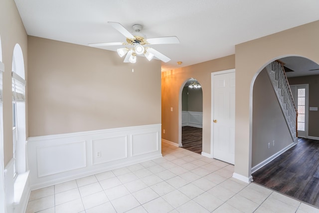 601 Black Oak Dr Unit 118, Dalton, GA 30721 - spare room featuring ceiling fan, arched walkways, wainscoting, light tile patterned floors, and stairs