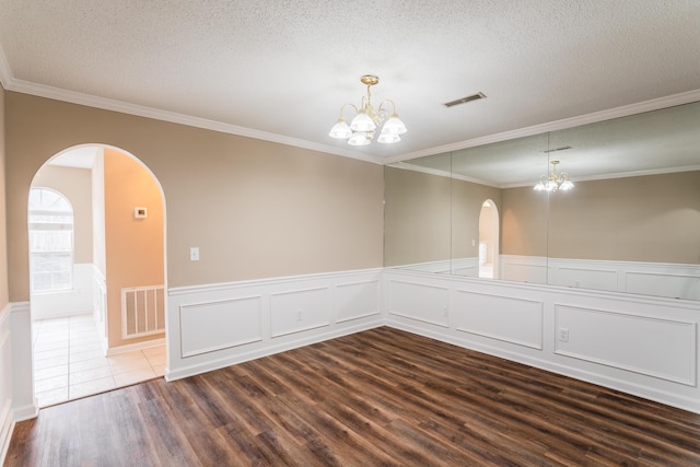 601 Black Oak Dr Unit 118, Dalton, GA 30721 - empty room with a chandelier, dark wood-style floors, arched walkways, crown molding, and a textured ceiling