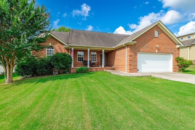 212 Cox Ln, Soddy Daisy, TN 37379 - ranch-style home with covered porch, brick siding, an attached garage, concrete driveway, and a front lawn