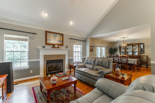 212 Cox Ln, Soddy Daisy, TN 37379 - living area featuring crown molding, healthy amount of natural light, lofted ceiling, a fireplace, and light wood finished floors