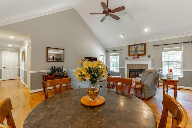 212 Cox Ln, Soddy Daisy, TN 37379 - dining space with light wood-style floors, ceiling fan, a fireplace, vaulted ceiling, and ornamental molding