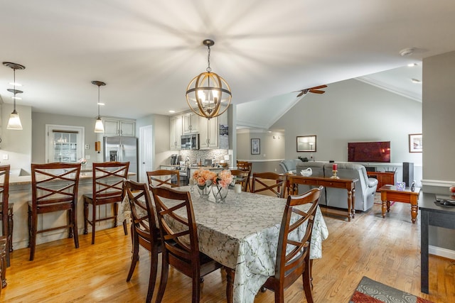 212 Cox Ln, Soddy Daisy, TN 37379 - dining area with light wood-type flooring, ceiling fan, a chandelier, and vaulted ceiling