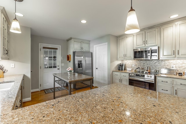 212 Cox Ln, Soddy Daisy, TN 37379 - kitchen with appliances with stainless steel finishes, light wood-style floors, light stone counters, backsplash, and glass insert cabinets