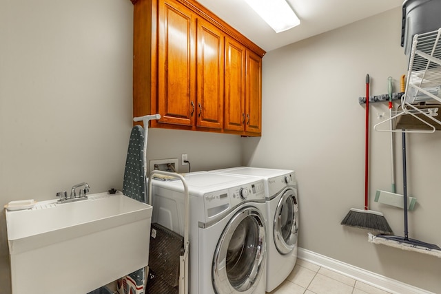212 Cox Ln, Soddy Daisy, TN 37379 - laundry area with cabinet space, washing machine and dryer, and light tile patterned floors