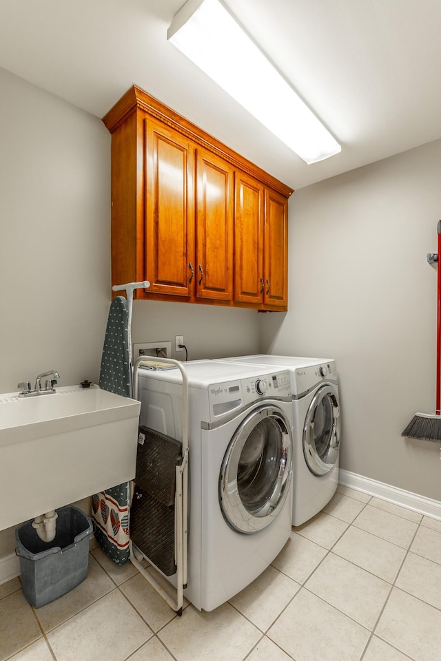 212 Cox Ln, Soddy Daisy, TN 37379 - laundry area with cabinet space, washing machine and dryer, and light tile patterned floors
