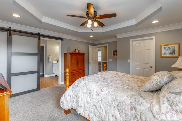 212 Cox Ln, Soddy Daisy, TN 37379 - carpeted bedroom featuring a barn door, a tray ceiling, crown molding, recessed lighting, and a ceiling fan