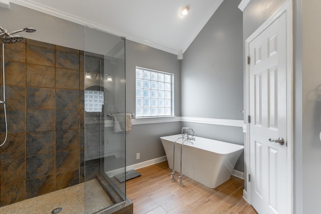 212 Cox Ln, Soddy Daisy, TN 37379 - full bath featuring ornamental molding, a shower stall, a freestanding tub, lofted ceiling, and wood finished floors