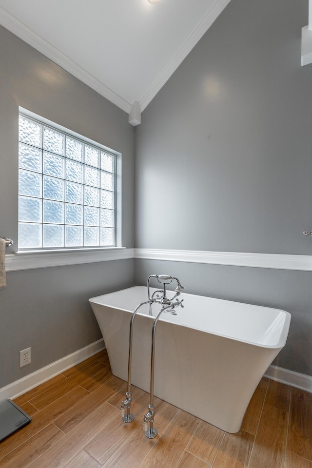 212 Cox Ln, Soddy Daisy, TN 37379 - bathroom with ornamental molding, a freestanding bath, wood finished floors, and vaulted ceiling