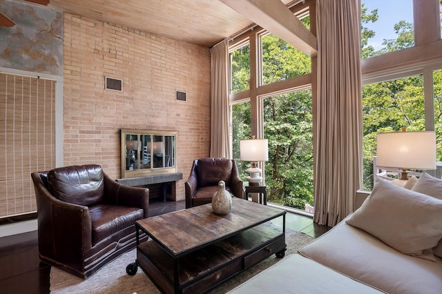 2554 Crestwood Dr, Chattanooga, TN 37415 - living area featuring a towering ceiling, wood ceiling, healthy amount of natural light, a ceiling fan, and brick wall
