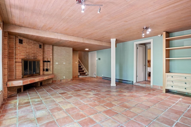 2554 Crestwood Dr, Chattanooga, TN 37415 - unfurnished living room with baseboard heating, wood ceiling, stairway, a brick fireplace, and brick wall