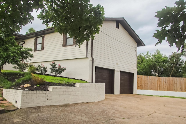 2730 Windthrush Dr, Chattanooga, TN 37421 - view of property exterior featuring an attached garage, concrete driveway, and brick siding
