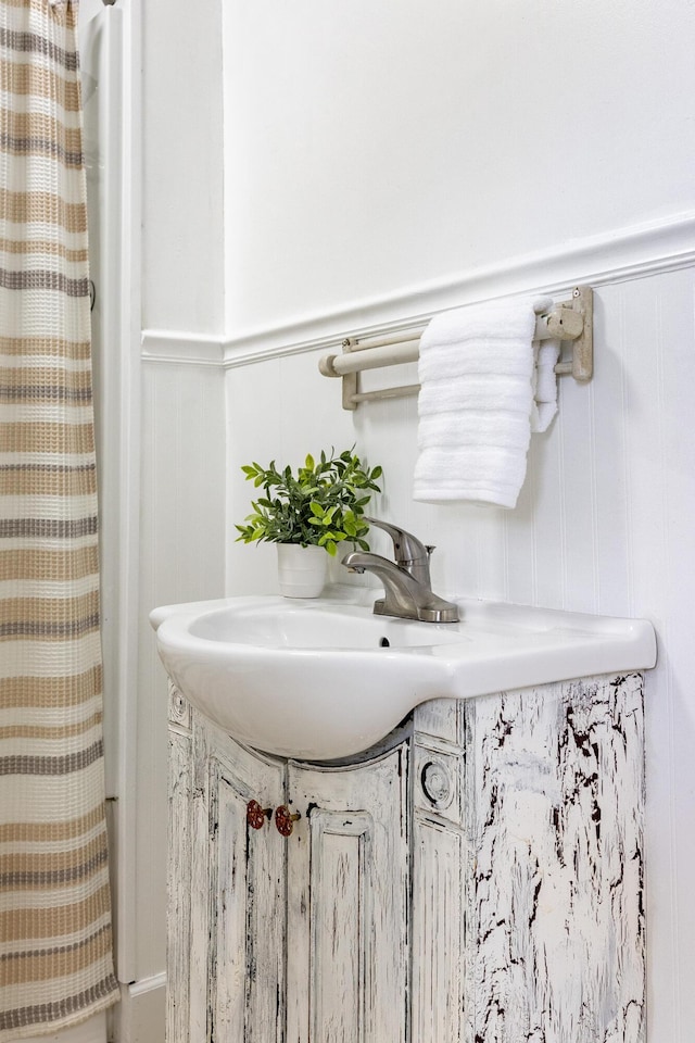 11387 Spring St, Soddy Daisy, TN 37379 - bathroom featuring vanity, a decorative wall, and wainscoting