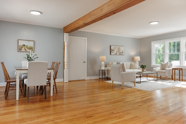 11387 Spring St, Soddy Daisy, TN 37379 - dining space with light wood finished floors, beam ceiling, and crown molding