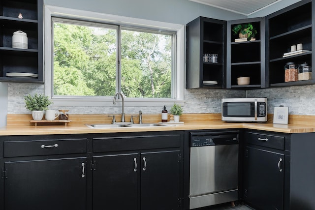 11387 Spring St, Soddy Daisy, TN 37379 - kitchen with appliances with stainless steel finishes, dark cabinets, wooden counters, decorative backsplash, and open shelves