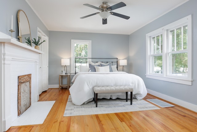 11387 Spring St, Soddy Daisy, TN 37379 - bedroom featuring wood finished floors, a brick fireplace, crown molding, and a ceiling fan