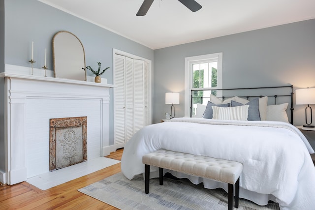 11387 Spring St, Soddy Daisy, TN 37379 - bedroom featuring a closet, wood finished floors, a fireplace, ceiling fan, and crown molding