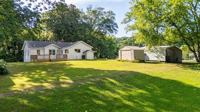 11387 Spring St, Soddy Daisy, TN 37379 - view of green lawn with an outbuilding, a wooden deck, and a detached carport