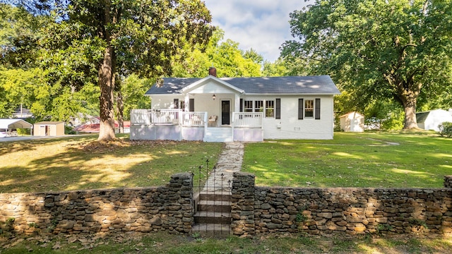 11387 Spring St, Soddy Daisy, TN 37379 - view of front of property with a front lawn, a storage unit, roof with shingles, and a deck