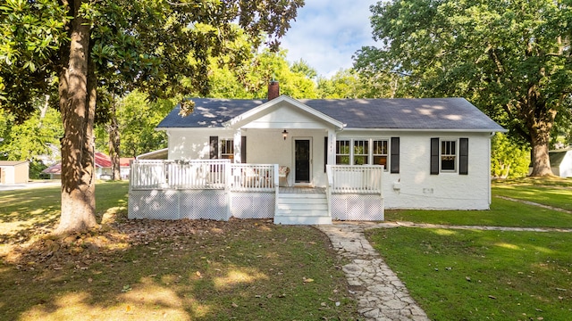 11387 Spring St, Soddy Daisy, TN 37379 - view of front of property featuring a front yard, a chimney, a deck, stucco siding, and roof with shingles