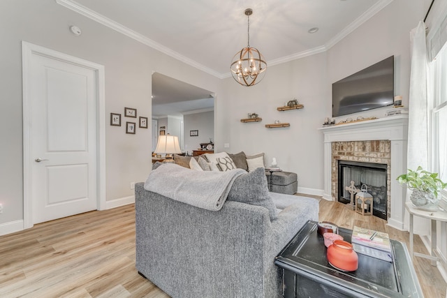 320 Kempton Ln Unit 2, Dalton, GA 30721 - living room featuring light wood-style floors, ornamental molding, a chandelier, and a brick fireplace