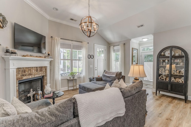 320 Kempton Ln Unit 2, Dalton, GA 30721 - living room featuring healthy amount of natural light, ornamental molding, light wood-style floors, a chandelier, and a fireplace