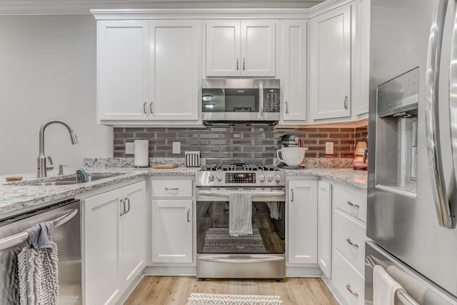 320 Kempton Ln Unit 2, Dalton, GA 30721 - kitchen featuring stainless steel appliances, white cabinetry, and tasteful backsplash