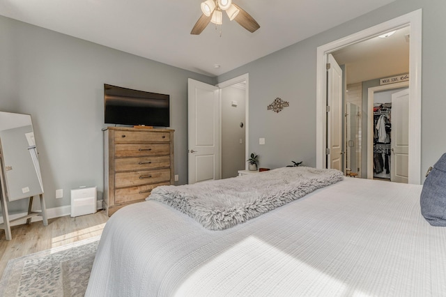 320 Kempton Ln Unit 2, Dalton, GA 30721 - bedroom featuring light wood-style floors, a walk in closet, and a ceiling fan