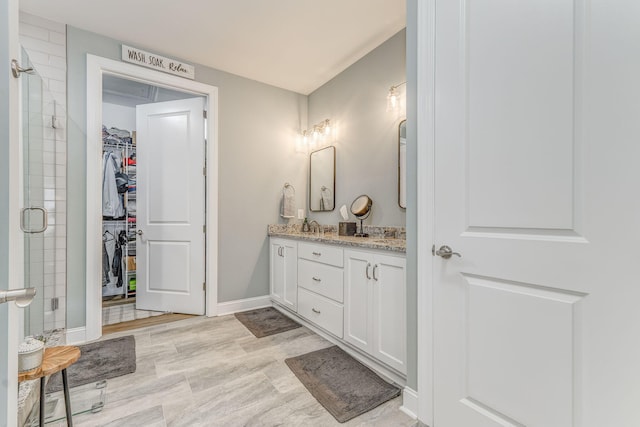 320 Kempton Ln Unit 2, Dalton, GA 30721 - bathroom with double vanity, a stall shower, and a walk in closet