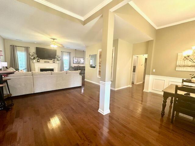 8041 Hamilton Mill Dr, Chattanooga, TN 37421 - living room featuring a ceiling fan, dark wood-type flooring, a fireplace, and crown molding