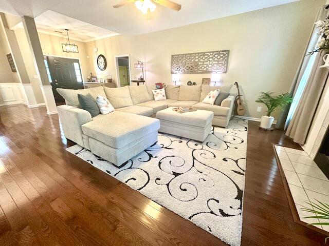 8041 Hamilton Mill Dr, Chattanooga, TN 37421 - living area featuring wood finished floors, a ceiling fan, wainscoting, and a chandelier