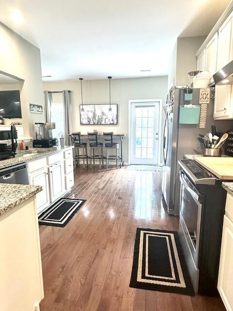 8041 Hamilton Mill Dr, Chattanooga, TN 37421 - kitchen with appliances with stainless steel finishes, dark wood-style floors, plenty of natural light, and white cabinets
