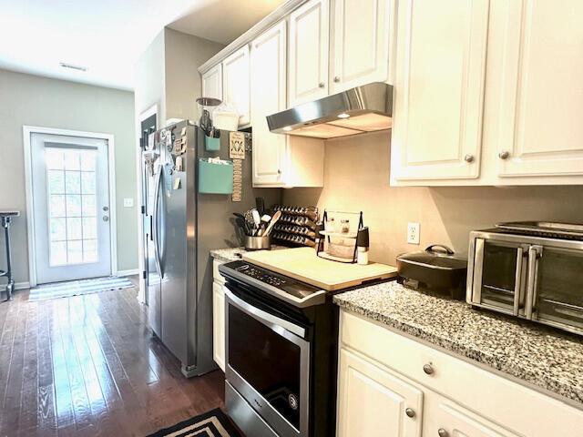 8041 Hamilton Mill Dr, Chattanooga, TN 37421 - kitchen with under cabinet range hood, appliances with stainless steel finishes, dark wood-type flooring, light stone counters, and white cabinets