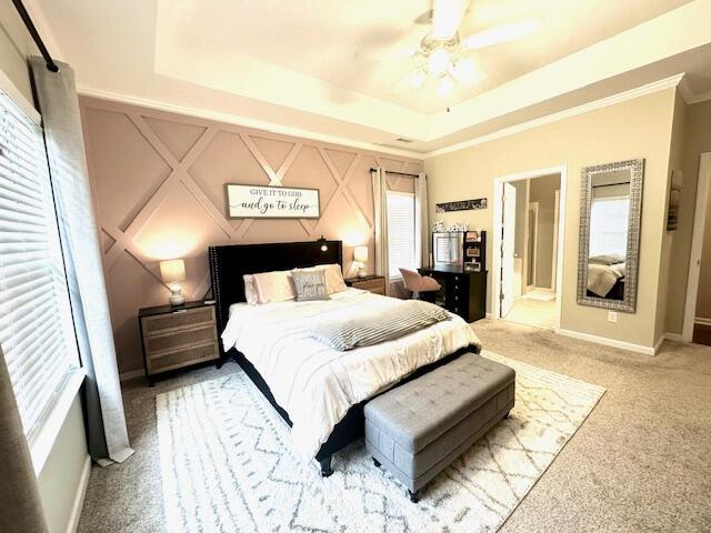 8041 Hamilton Mill Dr, Chattanooga, TN 37421 - bedroom featuring light carpet, a raised ceiling, a ceiling fan, crown molding, and a decorative wall