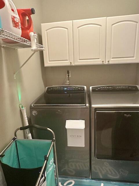 8041 Hamilton Mill Dr, Chattanooga, TN 37421 - laundry area featuring washing machine and dryer and cabinet space